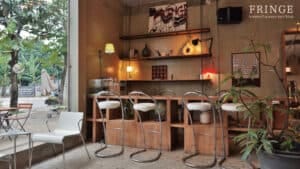 Mismatched bar stools along the counter amid eclectic boho decor at Fringe.th