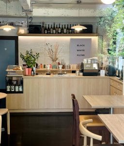 Maled Coffee Roasters' sparse light-wood counter with a Black White Filter menu board