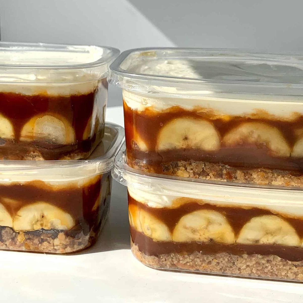 Layered banoffee cake with banana, caramel and cream in takeaway tubs at Maled Coffee Roasters