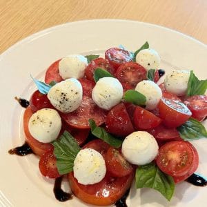 Caprese salad of cherry tomatoes, mozzarella and basil with balsamic at The Larder Cafe & Bar