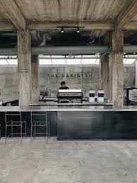 Industrial concrete coffee bar beneath the Baristro sign at The Baristro at Train Station