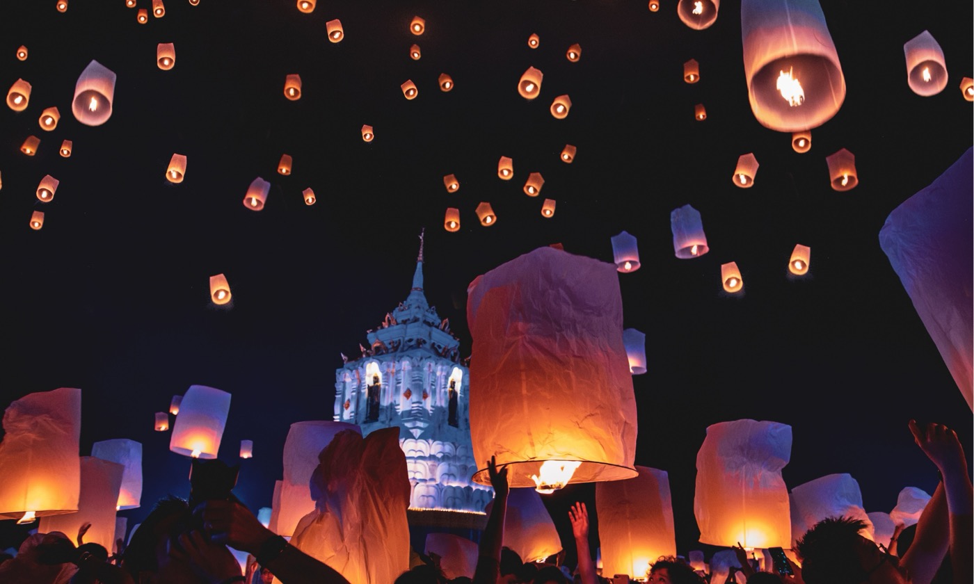 Yi Peng sky lanterns rising over Chiang Mai at night