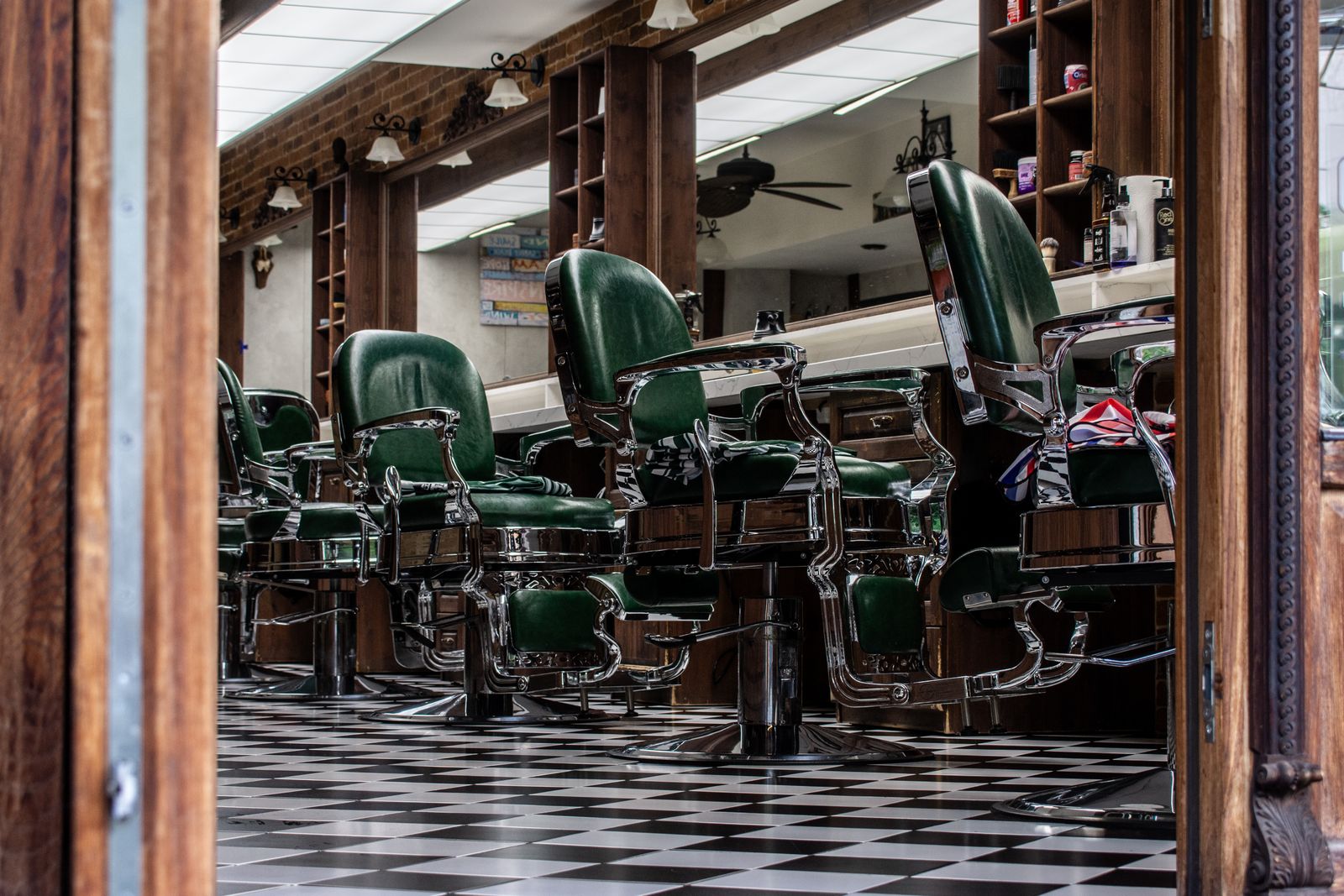 A classic barbershop interior with vintage leather chairs and a checkered floor